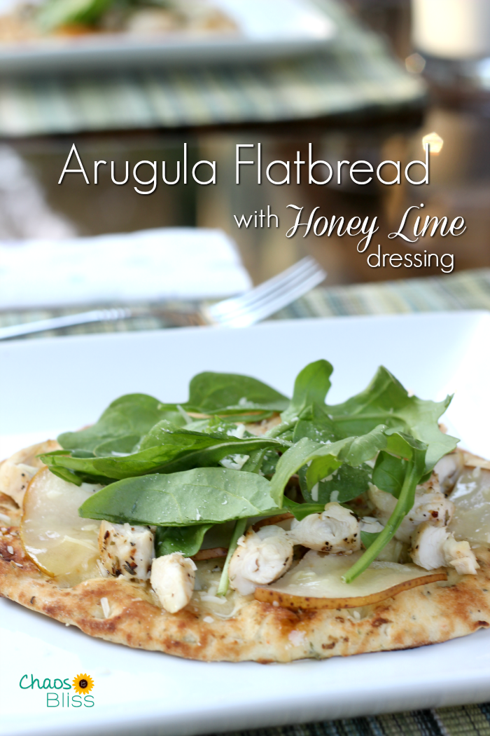 Arugula flatbread with pears, chicken, blue cheese and a made-from-scratch honey lime dressing is an easy dinner recipe for family or friends!