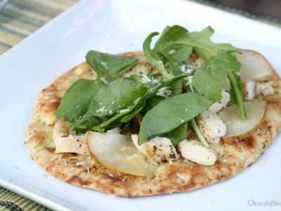 Arugula flatbread with pears, chicken, blue cheese and a made-from-scratch honey lime dressing is an easy dinner recipe for family or friends!