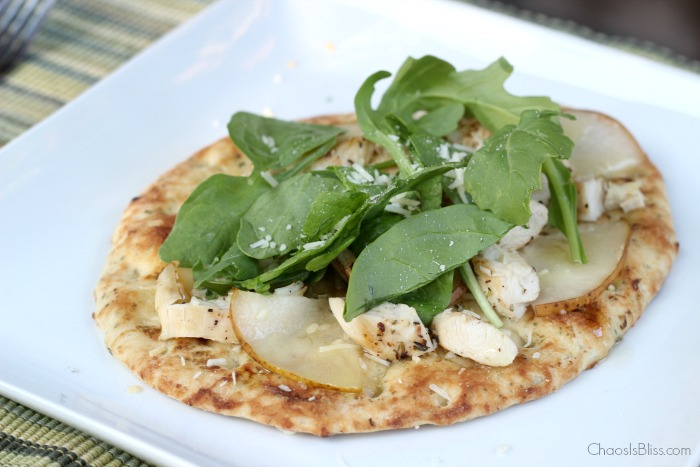 Arugula flatbread with pears, chicken, blue cheese and a made-from-scratch honey lime dressing is an easy dinner recipe for family or friends!